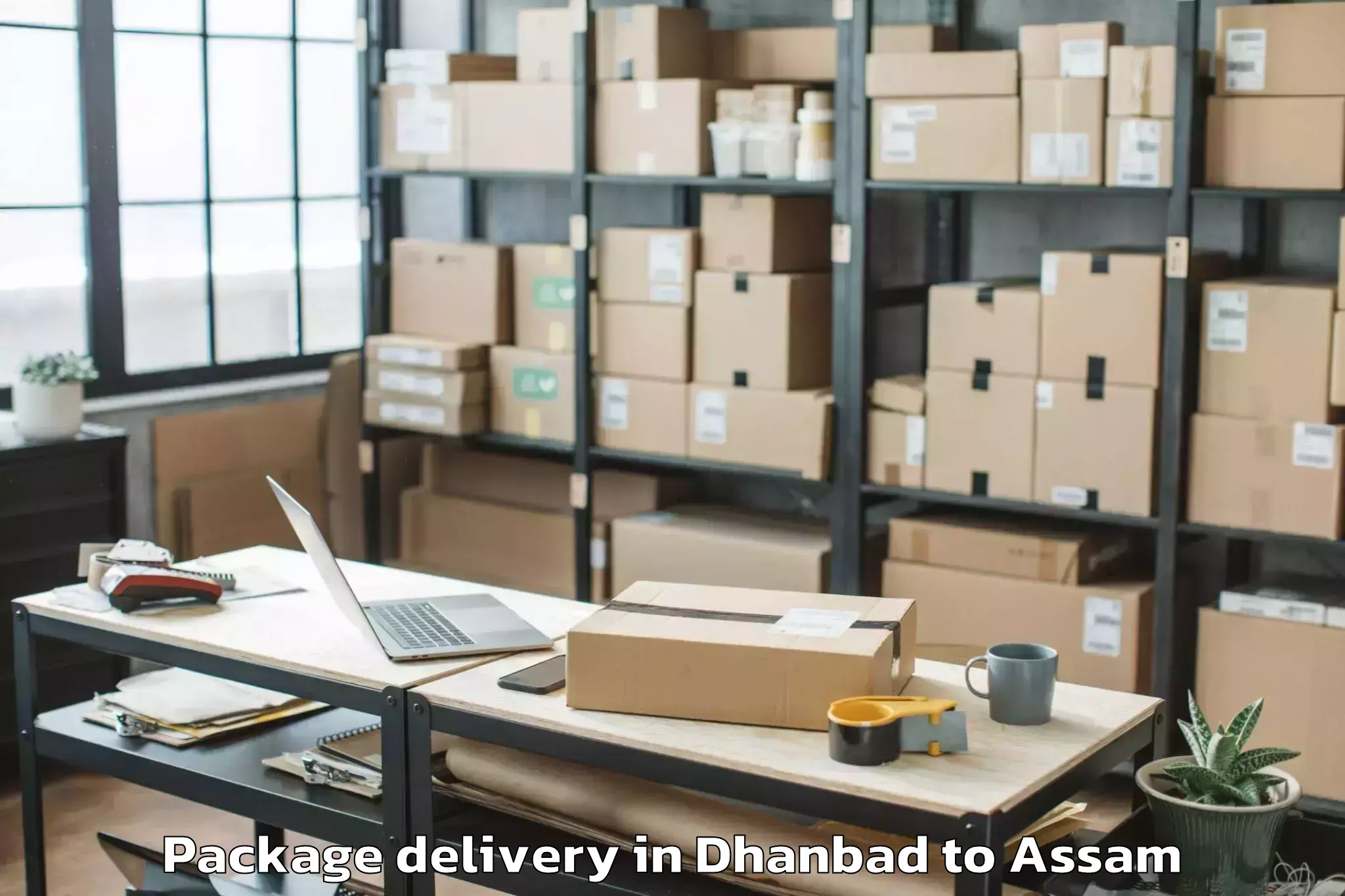 Quality Dhanbad to Muhimari Bilar Pathar Package Delivery